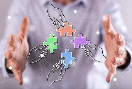 Teamwork concept between hands of a man in background