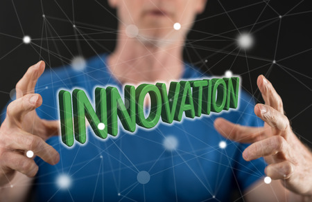 Innovation concept between hands of a man in backgroundの写真素材