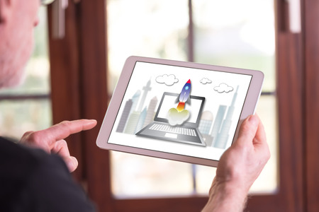 Man holding a tablet showing startup conceptの写真素材