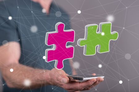 Unity concept above a smartphone held by a man in backgroundの写真素材