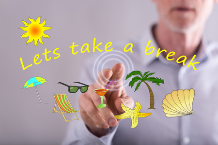 Man touching a vacation time concept on a touch screen with his fingerの写真素材