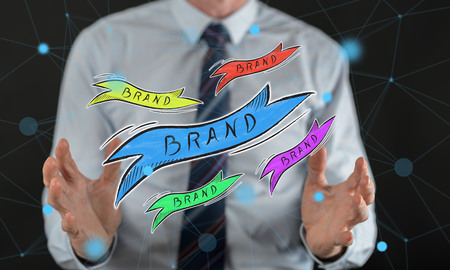 Brand concept between hands of a man in backgroundの写真素材