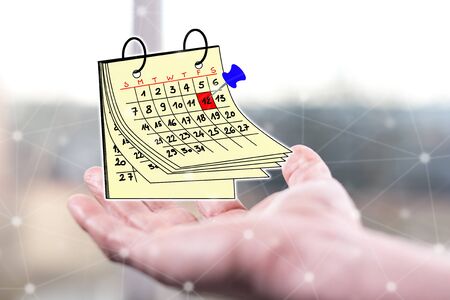 Calendar concept above a hand of a manの写真素材