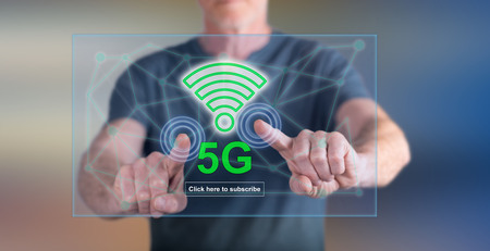 Man touching a 5g concept on a touch screen with his fingersの写真素材