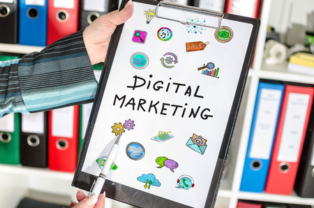 Woman holding a clipboard with digital marketing conceptの写真素材