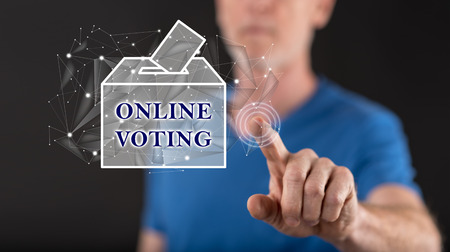 Man touching an online voting concept on a touch screen with his fingerの写真素材