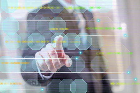 Man touching an abstract technology concept on a touch screen with his fingers