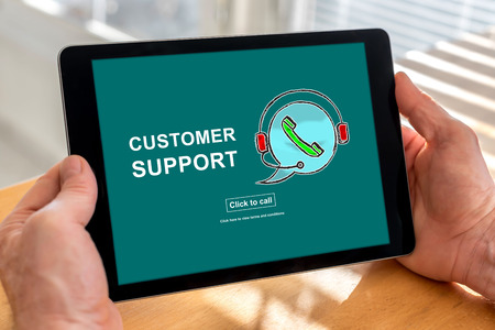 Male hands holding a tablet with customer support conceptの写真素材