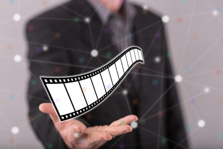 Movies, video and cinema concept above the hand of a man in backgroundの写真素材