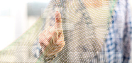 Woman touching a virtual technology concept on a touch screen with her finger