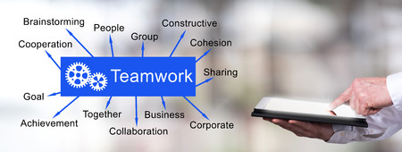 Man using a tablet with teamwork conceptの写真素材