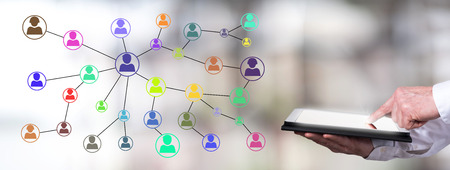 Man using a tablet with social network conceptの写真素材