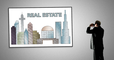 Man looking at real estate concept through binocularsの写真素材