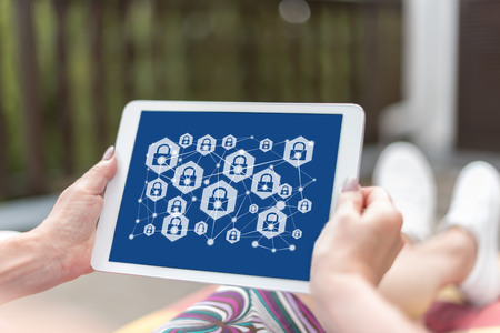 Female hands holding a tablet with network safety concept