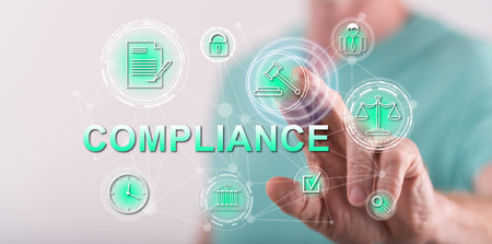 Man touching a compliance concept on a touch screen with his finger