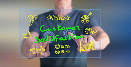 Man touching a customer satisfaction concept on a touch screen with his fingersの写真素材