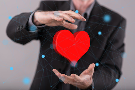 Love concept between hands of a man in background