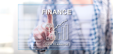 Woman touching a finance concept on a touch screen with her fingerの写真素材