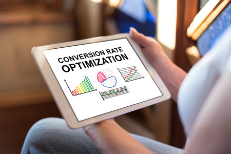 Woman holding a tablet showing conversion rate optimization conceptの写真素材