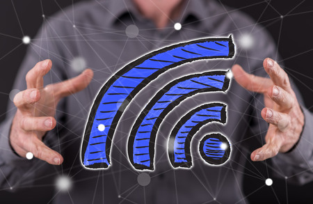 Wifi concept between hands of a man in backgroundの写真素材