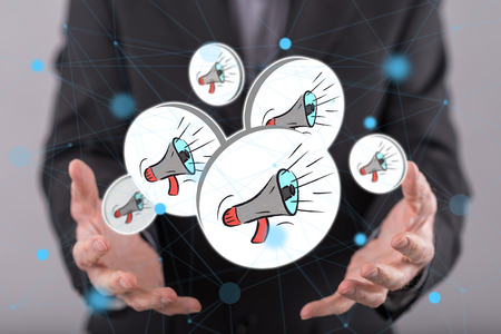 Communication concept above the hands of a man in backgroundの写真素材