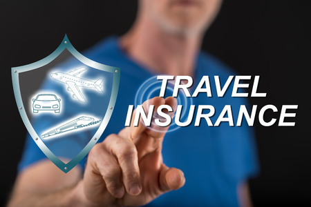 Man touching a travel insurance concept on a touch screen with his fingerの写真素材