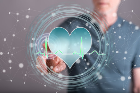 Man touching a corporate financial checkup concept on a touch screen with his fingerの写真素材