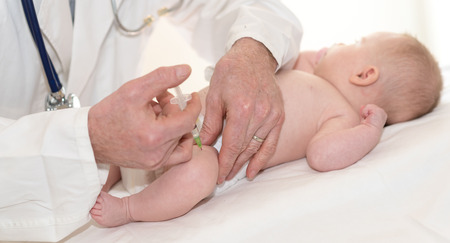 Little baby getting a vaccine shot in legの写真素材