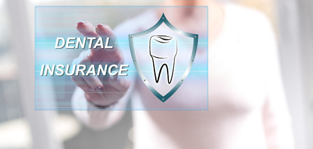 Woman touching a dental insurance concept on a touch screen with her fingersの写真素材