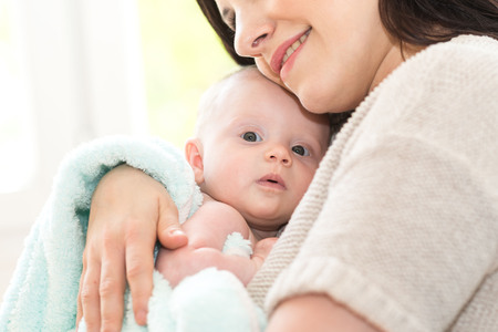 Portrait of happy mother with her cute baby girlの写真素材