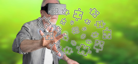 Man with vr headset touching a teamwork concept on a touch screen with his fingerの写真素材