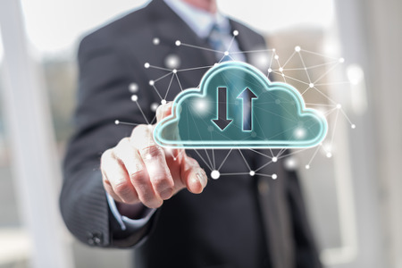 Man touching a cloud networking concept on a touch screen with his fingersの写真素材