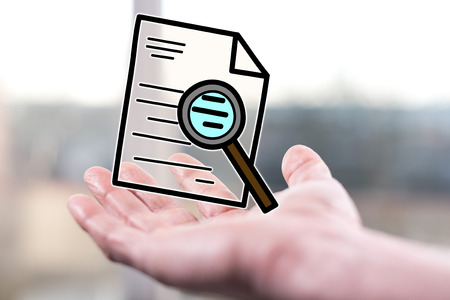 Audit concept above a hand of a manの写真素材