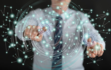 Man touching a virtual network on a touch screen with his fingersの写真素材