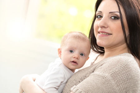 Portrait of happy mother with her cute baby girlの写真素材