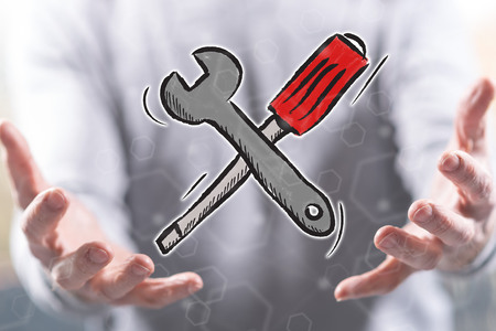 Maintenance service concept above the hands of a man in backgroundの写真素材