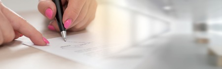 Woman signing a legal documentの写真素材