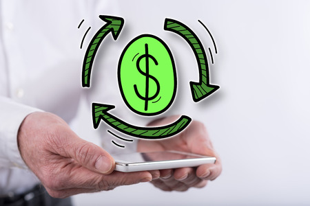 Exchange concept above a smartphone held by handsの写真素材