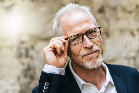 Portrait of handsome mature man, outdoors, light effectの写真素材
