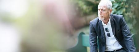 Portrait of thoughtful mature man outdoorsの写真素材
