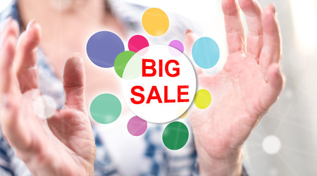 Big sale concept between hands of a woman in background