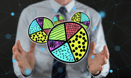 Business results concept between hands of a man in backgroundの写真素材