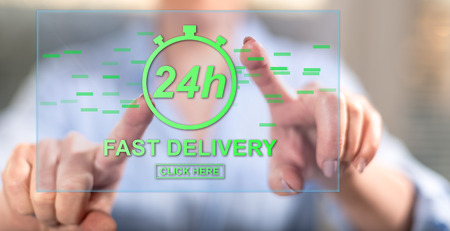 Woman touching a fast delivery concept on a touch screen with her fingersの写真素材