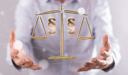 Law concept above the hands of a man in backgroundの写真素材