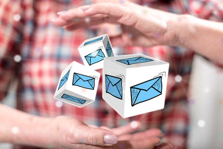 E-mail concept between hands of a woman in backgroundの写真素材