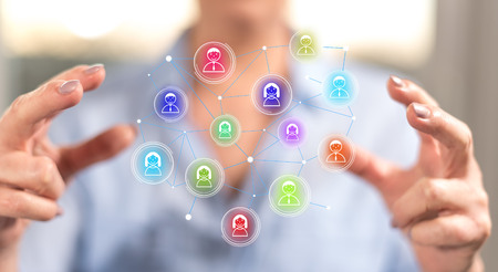 Social network concept between hands of a woman in background