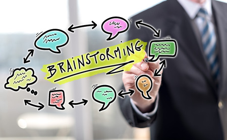 Man touching a brainstorming concept on a touch screen with a stylus pen