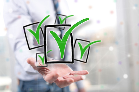 Validation concept above the hand of a man in backgroundの写真素材