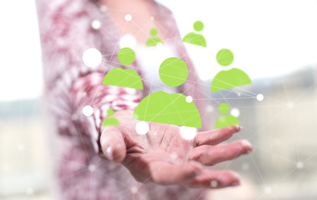 Social network concept above the hand of a woman in backgroundの写真素材