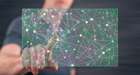 Man touching an artificial intelligence illustration on a touch screen with his fingerの写真素材